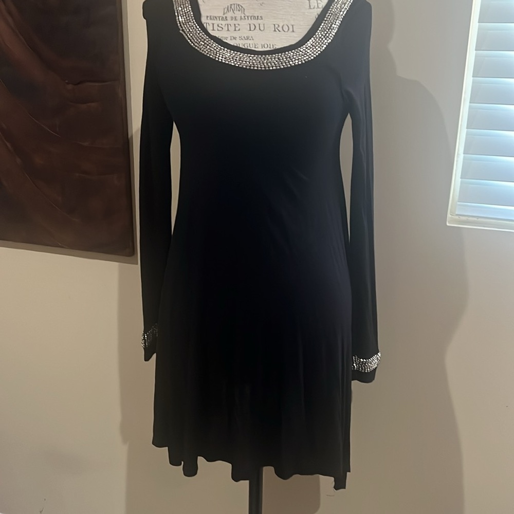 Black with silver embellishment on necklace and end of sleeves.